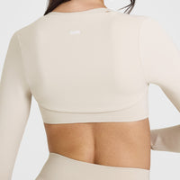 SoftMotion™ Long Sleeve Shrug with White Logo | Sand