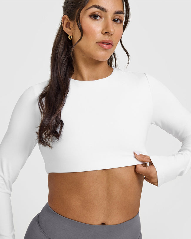 SoftMotion™ Long Sleeve Crop Top with White Logo | White