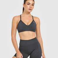 EnhanceLift™ Seamless Strappy Sports Bra with White Logo | Coal