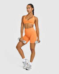 Effortless Seamless Halter Neck Sports Bra with White Logo | Apricot Orange