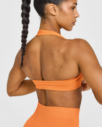 Effortless Seamless Halter Neck Sports Bra with White Logo | Apricot Orange