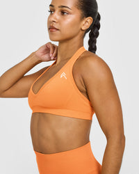 Effortless Seamless Halter Neck Sports Bra with White Logo | Apricot Orange