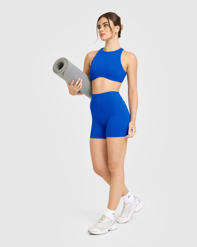 SoftMotion™ High Neck Sports Bra with White Logo | Light Cobalt Blue