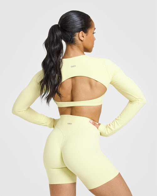SoftMotion™ Long Sleeve Crop Top with White Logo | Pastel Yellow