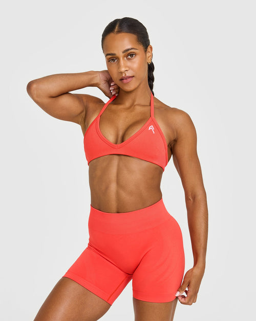 EnhanceLift™ Seamless Minimal Halter Neck Bralette with White Logo | Charged Coral