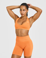 Effortless Seamless Halter Neck Sports Bra with White Logo | Apricot Orange