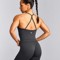 EnhanceLift™ Seamless Strappy Racer Vest with Built in Bra Shelf with Grey Logo | Coal