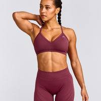 EnhanceLift™ Seamless Strappy Sports Bra with Grey Logo | Burnt Maroon