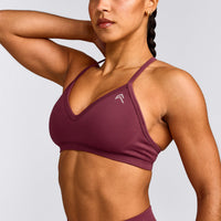 EnhanceLift™ Seamless Strappy Sports Bra with Grey Logo | Burnt Maroon