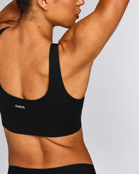 SoftMotion™ Longline Sports Bra with Gray Logo | Black