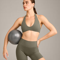 SoftMotion™ Minimal Halter Neck Bralette with Grey Logo | Alpine Green