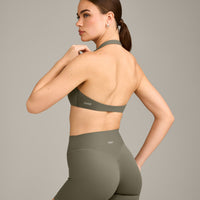 SoftMotion™ Minimal Halter Neck Bralette with Grey Logo | Alpine Green