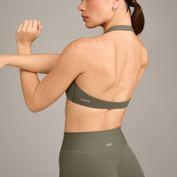 SoftMotion™ Minimal Halter Neck Bralette with Grey Logo | Alpine Green