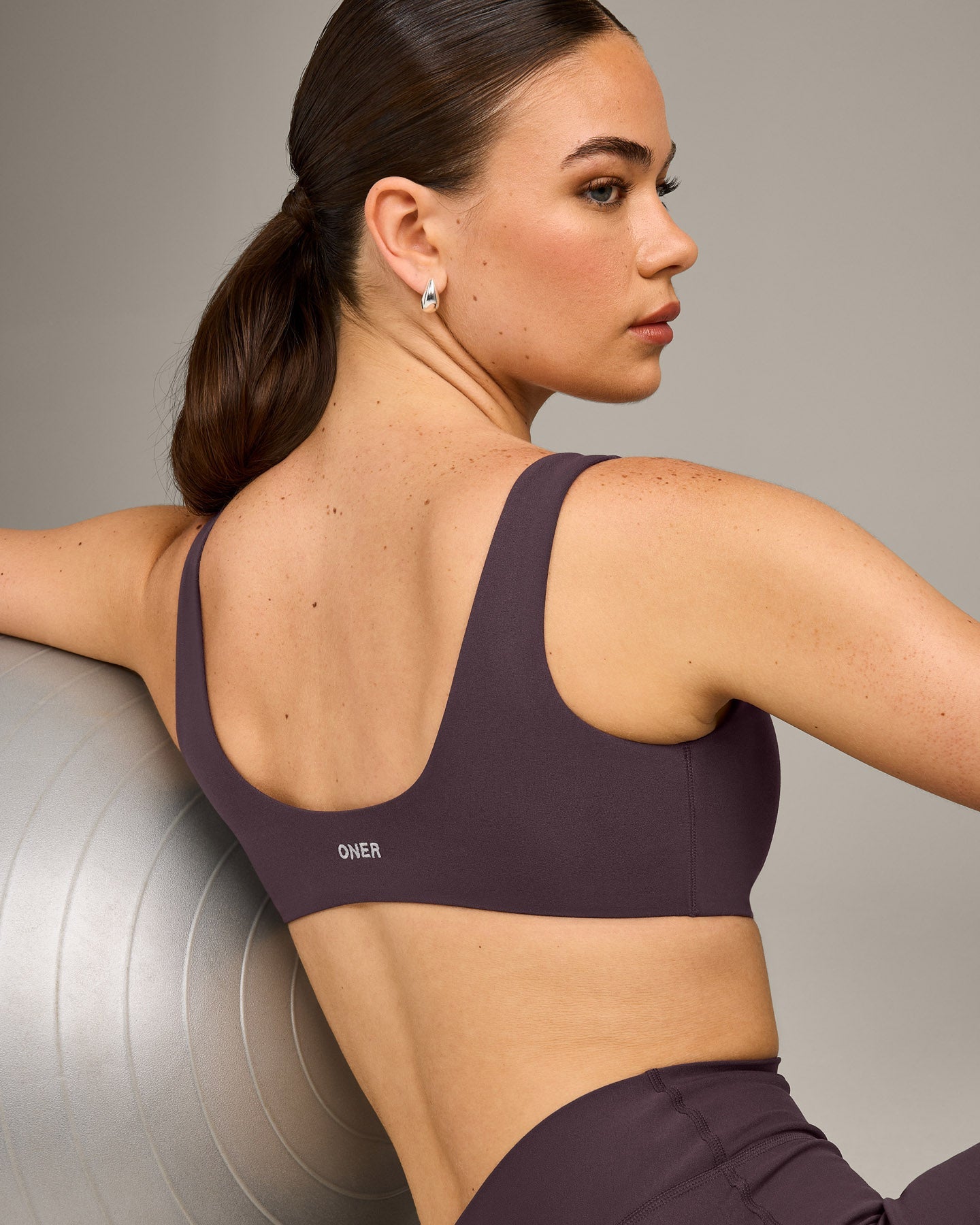 SoftMotion™ Scoop Back Bralette with Grey Logo | Dark Umber Brown