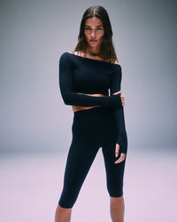 SoftMotion™ High Waisted Capri Leggings with Grey Logo | Black
