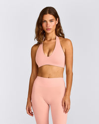 SoftMotion™ Minimal Halter Neck Bralette with Grey Logo | Peach Orange