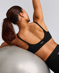 SoftMotion™ Strappy Sports Bra with Grey Logo | Black