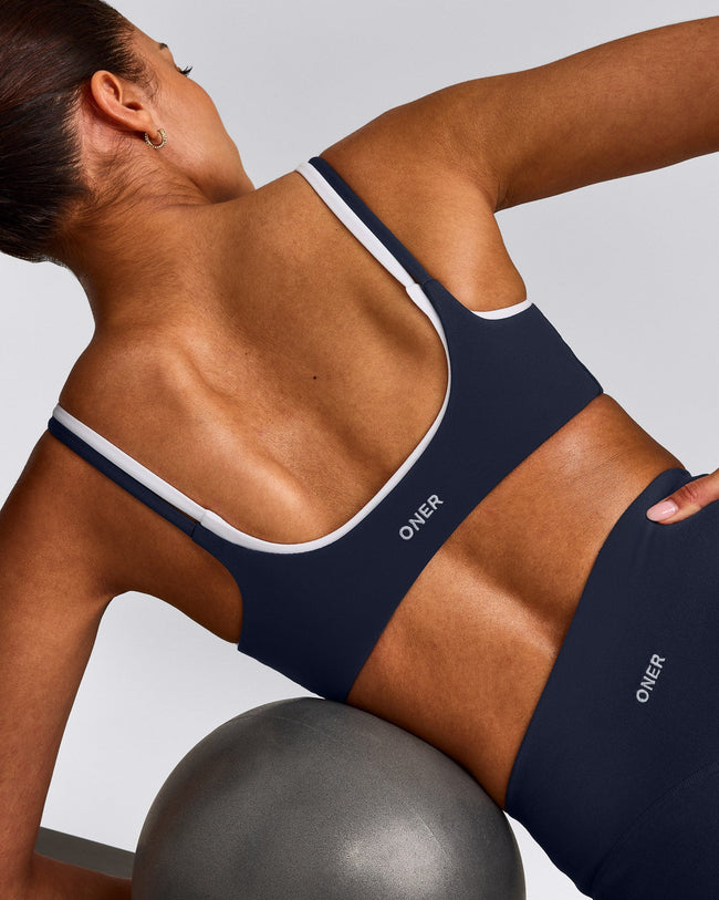 SoftMotion™ Strappy Sports Bra with Grey Logo | True Blue