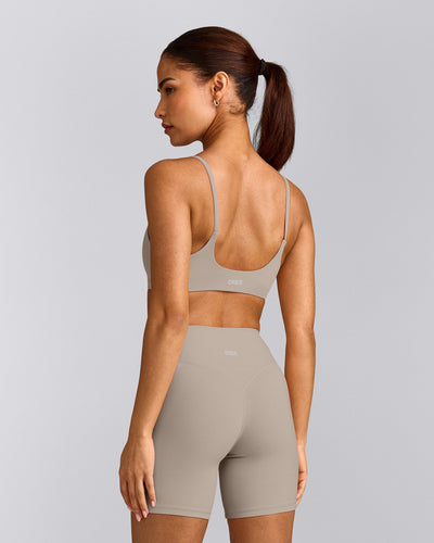 SoftMotion™ Strappy Sports Bra with White Logo | Warm Sand