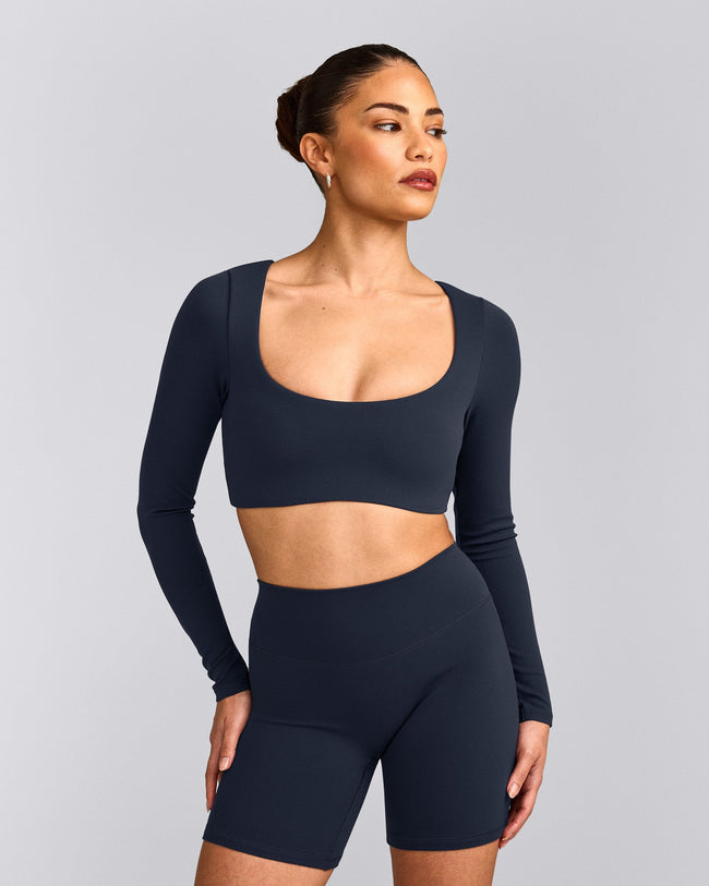 SoftMotion™ Scoop Neck Long Sleeve Crop Top with Built in Bra Shelf with Grey Logo | True Blue