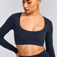 SoftMotion™ Scoop Neck Long Sleeve Crop Top with Built in Bra Shelf with Grey Logo | True Blue