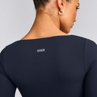 SoftMotion™ Scoop Neck Long Sleeve Crop Top with Built in Bra Shelf with Grey Logo | True Blue