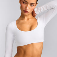 SoftMotion™ Scoop Neck Long Sleeve Crop Top with Built in Bra Shelf with Grey Logo | White