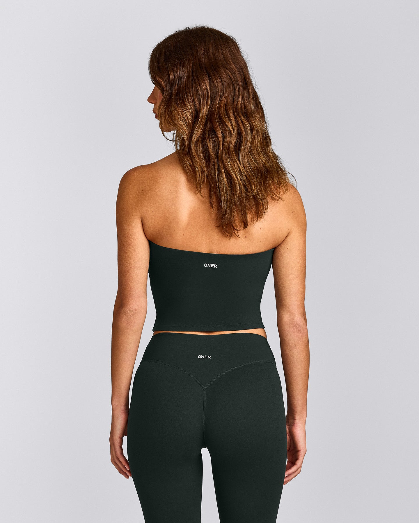 SoftMotion™ Bandeau Mid Vest with Built in Bra Shelf with Grey Logo | Emerald Noir