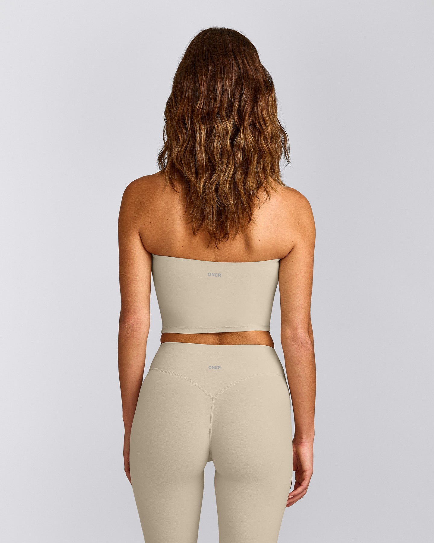 SoftMotion™ Bandeau Mid Vest with Built in Bra Shelf with Grey Logo | Oatmeal