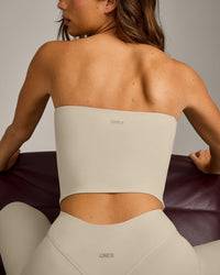 SoftMotion™ Bandeau Mid Vest with Built in Bra Shelf with Grey Logo | Oatmeal