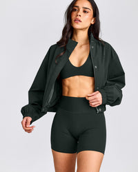 SoftMotion™ Minimal Halter Neck Bralette with Grey Logo | Emerald Noir