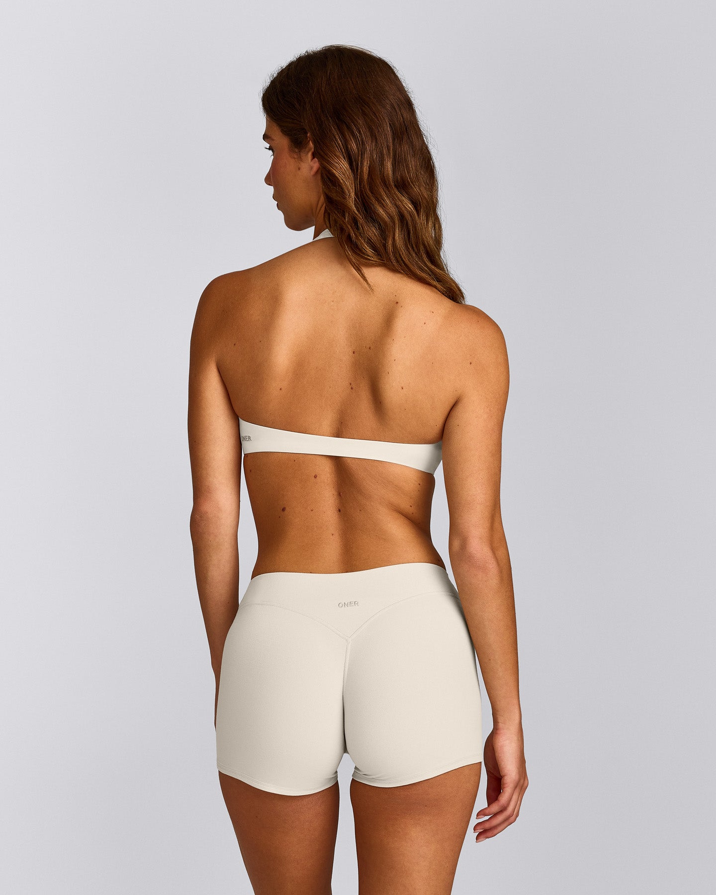 SoftMotion™ Minimal Halter Neck Bralette with Grey Logo | Marshmallow White