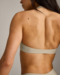 SoftMotion™ Minimal Halter Neck Bralette with Grey Logo | Oatmeal