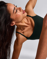 SoftMotion™ Strappy Sports Bra with Grey Logo | Emerald Noir