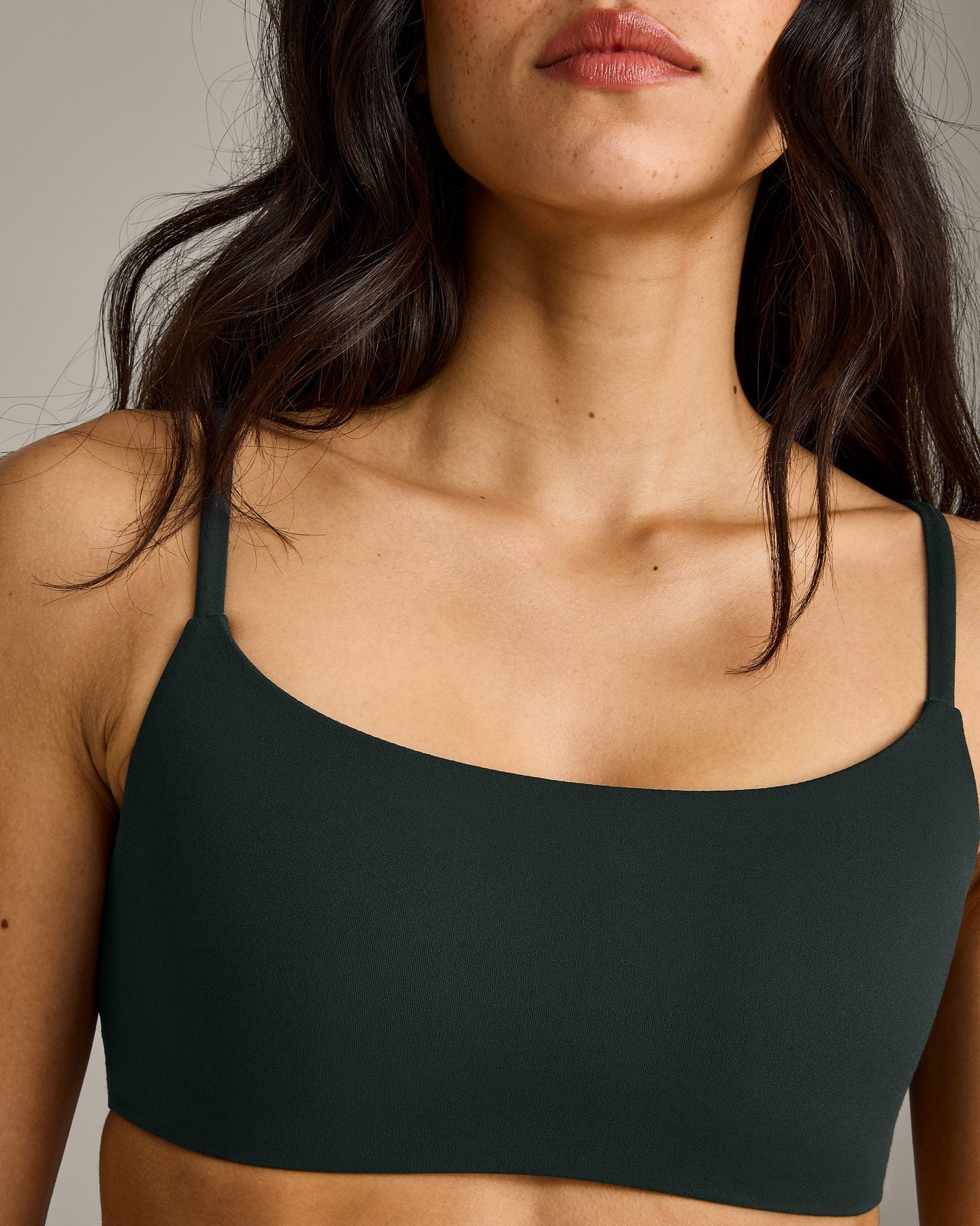 SoftMotion™ Strappy Sports Bra with Grey Logo | Emerald Noir