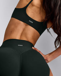 SoftMotion™ Strappy Sports Bra with Grey Logo | Emerald Noir