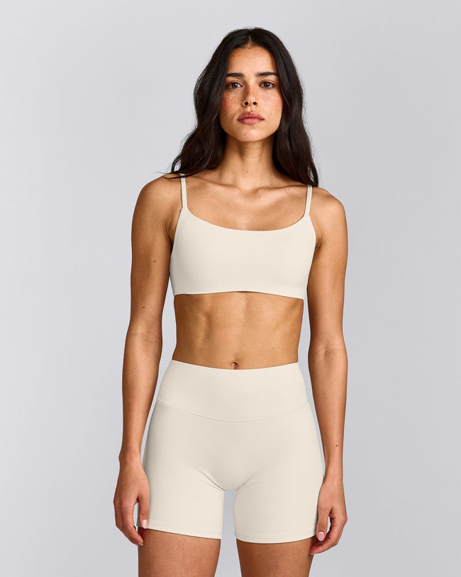 SoftMotion™ Strappy Sports Bra with Grey Logo | Marshmallow White