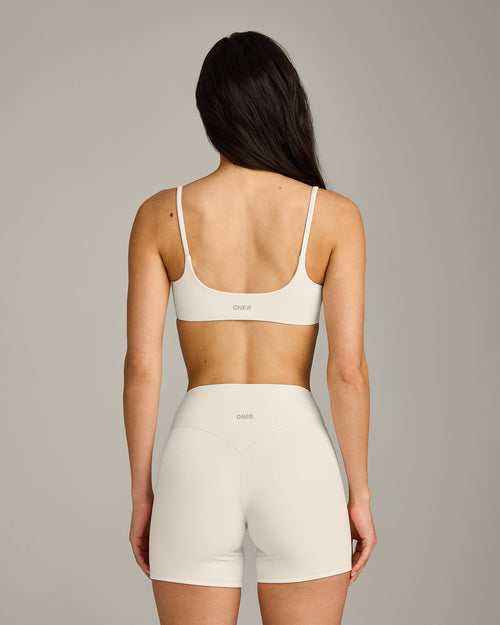 SoftMotion™ Strappy Sports Bra with Grey Logo | Marshmallow White