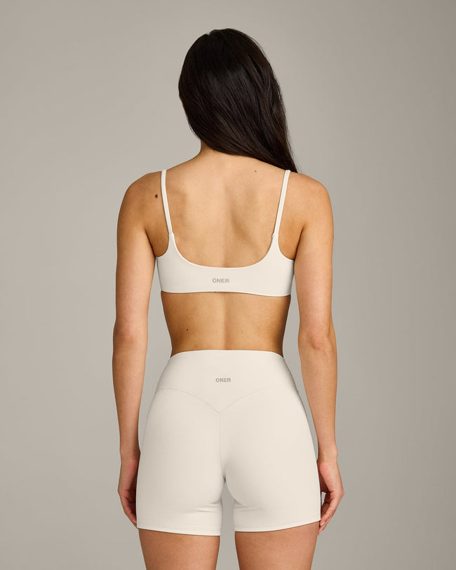 SoftMotion™ Strappy Sports Bra with Grey Logo | Marshmallow White