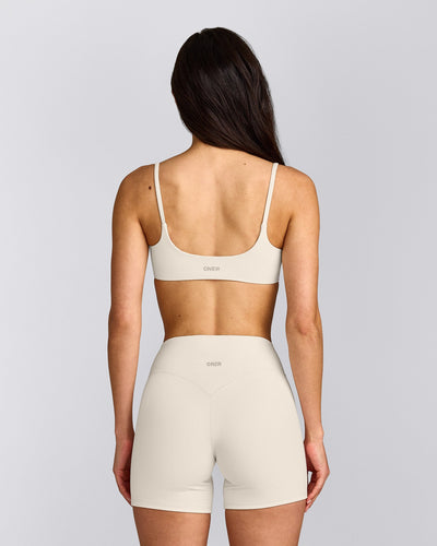 SoftMotion™ Strappy Sports Bra with Grey Logo | Marshmallow White