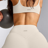 SoftMotion™ Strappy Sports Bra with Grey Logo | Marshmallow White