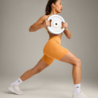 EffortlessLift™ Seamless Mid Rise Shorts with Grey Logo | Powdered Orange