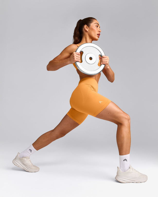 EffortlessLift™ Seamless Mid Rise Shorts with Gray Logo | Powdered Orange