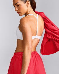 UnifiedMove™ T Back Minimal Bralette with Reflective Logo | White