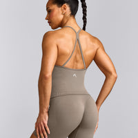 EnhanceLift™ Seamless Strappy Racer Tank Top with Built in Bra Shelf with Gray Logo | Warm Minky