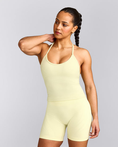 EnhanceLift™ Seamless Strappy Racer Tank Top with Built in Bra Shelf with Gray Logo | Pastel Yellow