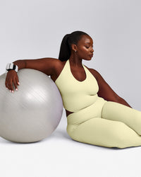 SoftMotion™ Halter Neck Mid Tank Top with Built in Bra Shelf with Gray Logo | Pastel Yellow