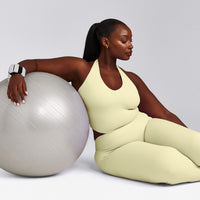 SoftMotion™ Halter Neck Mid Tank Top with Built in Bra Shelf with Gray Logo | Pastel Yellow