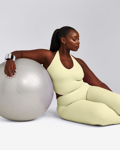 SoftMotion™ Halter Neck Mid Tank Top with Built in Bra Shelf with Gray Logo | Pastel Yellow
