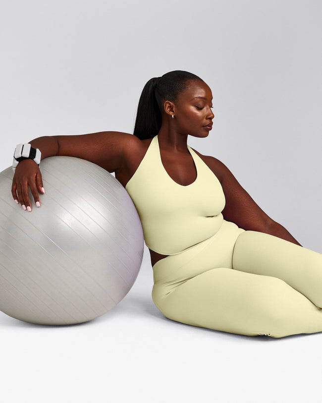 SoftMotion™ Halter Neck Mid Tank Top with Built in Bra Shelf with Gray Logo | Pastel Yellow